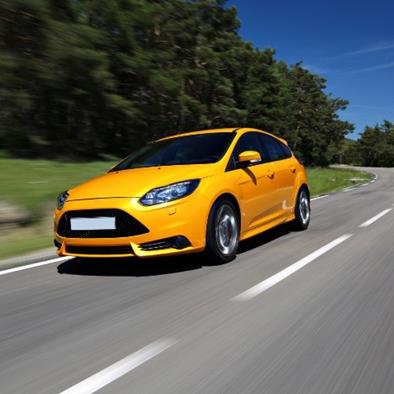 Yellow-orange car driving on a road
