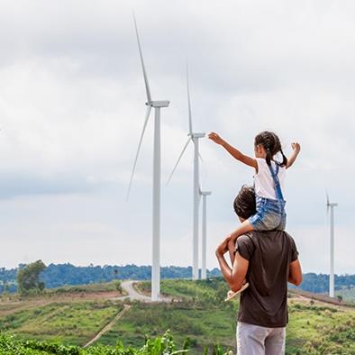 a father shows his daughter windmills