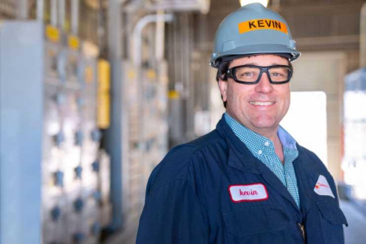 Man in hardhat and goggles smiling