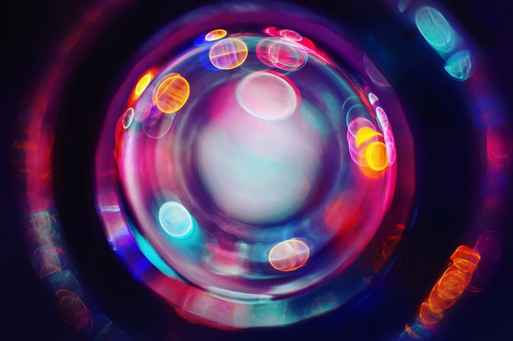 circles of colorful glowing rings and dots on a black background 