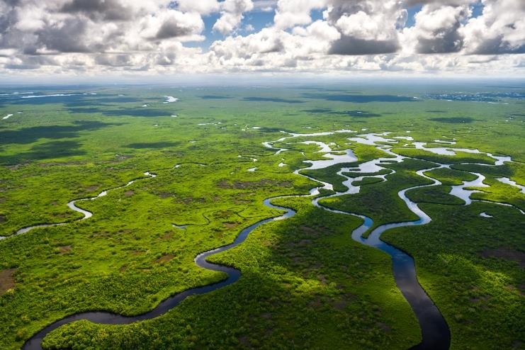 Clouds over a field with winding rivers