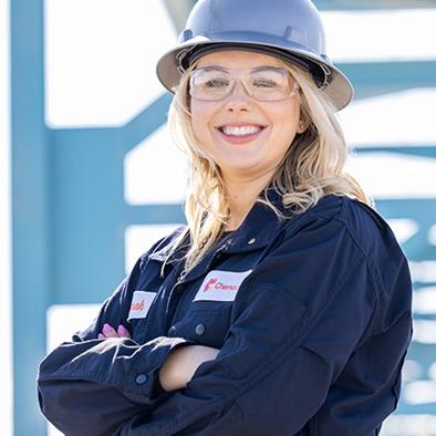 Woman wearing hardhat and safety glasses