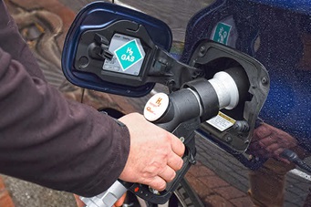 An image of a hand filling a car with hydrogen fuel.