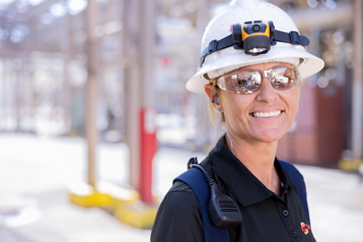 Woman in hardhat and safety glasses