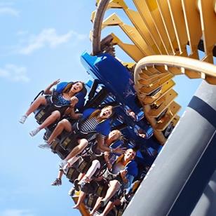 people riding a hang down roller coaster