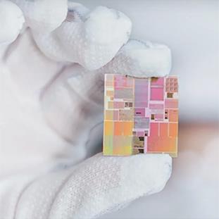 Gloved hand holding a semiconductor