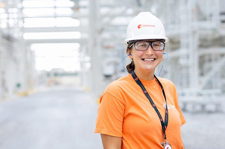 Woman wearing hardhat and lanyard