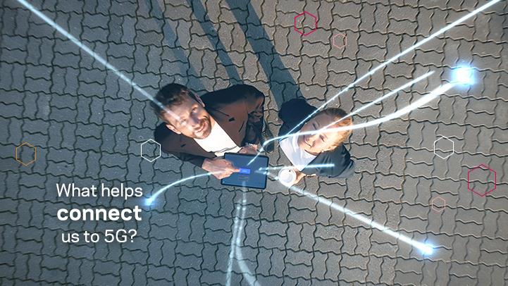 two people looking up as lights shoot out of a tablet