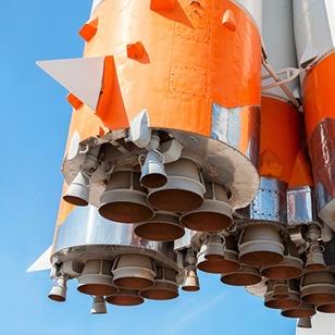 closeup bottom shot of orange and white space rocket engines 