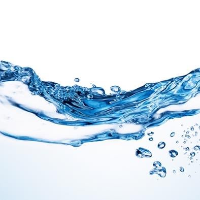 horizontal wave of water and a few bubbles on blue background