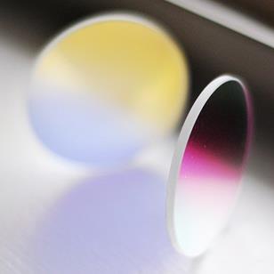two round dichroic glass lenses