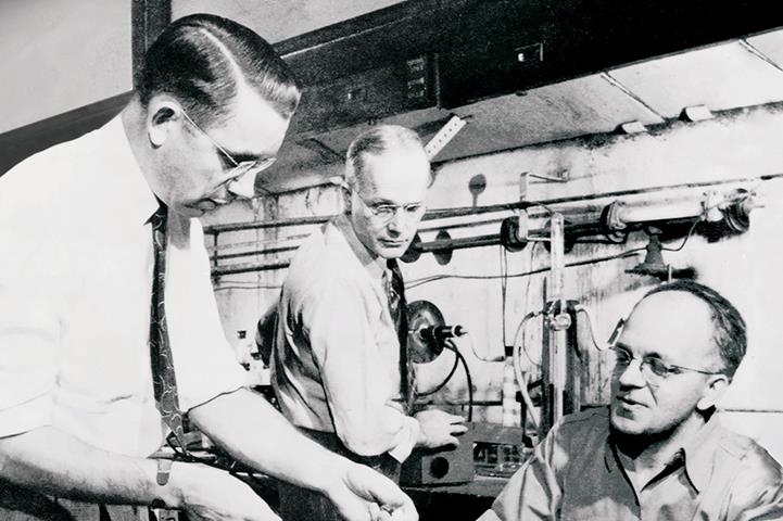 black and white photo of dr roy plunkett and two other dupont chemists