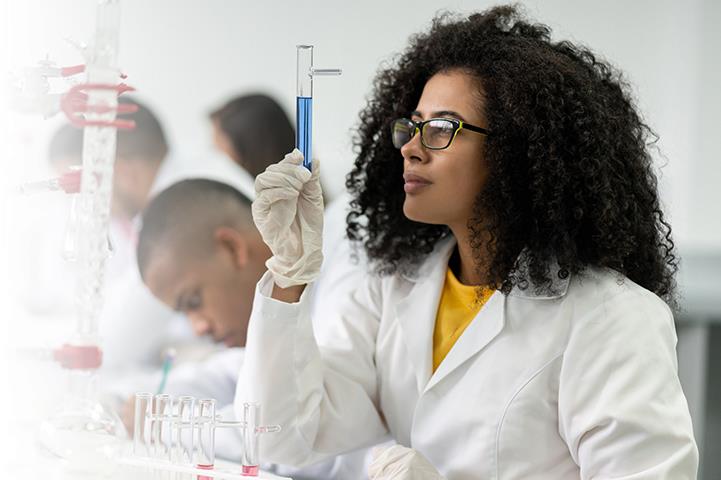 A young Black student in a chemistry lab. 
