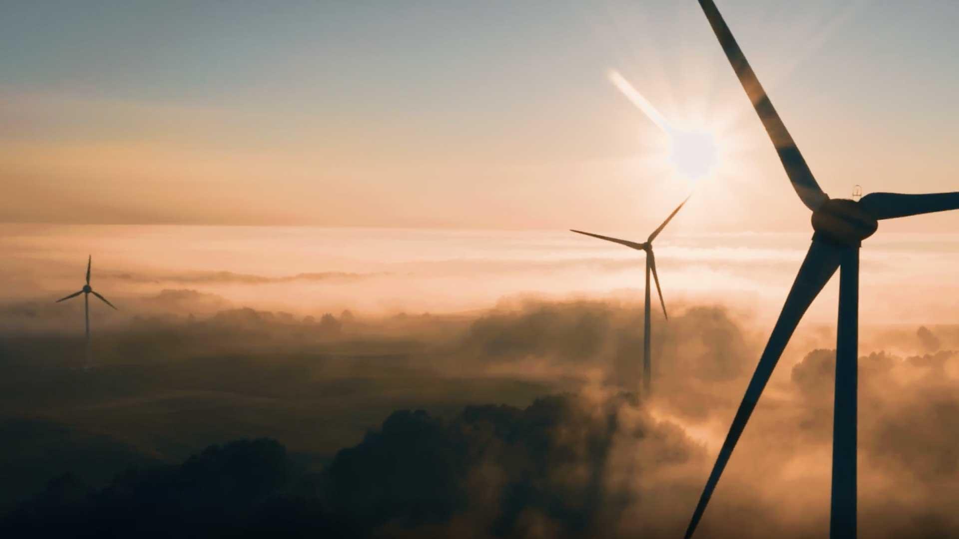 Windmills peaking above clouds