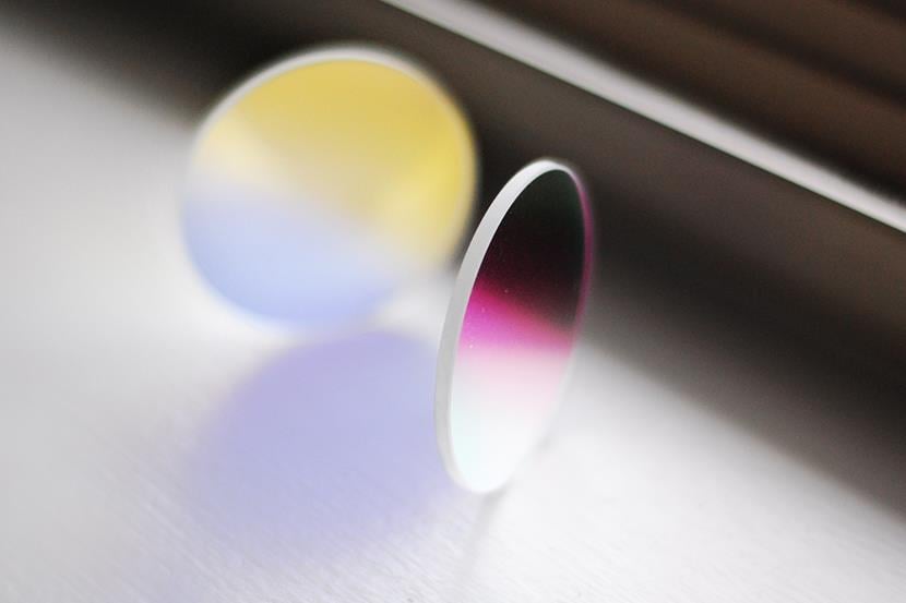 two round dichroic glass lenses