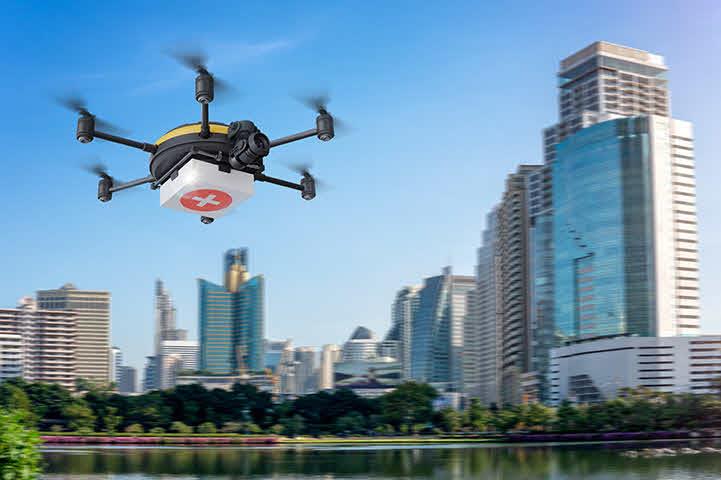 An image of a drone flying over a city lake.