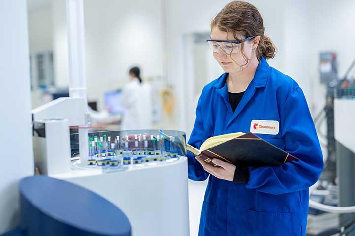 Scientist placing a sample onto small test tubes