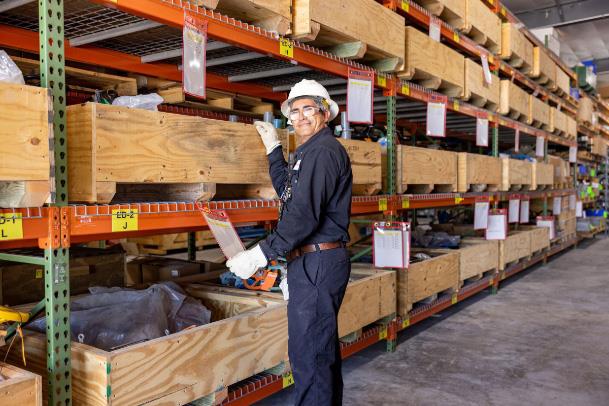 Man standing in front of lumber storage