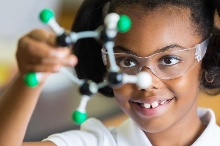 Young girl with chemistry model