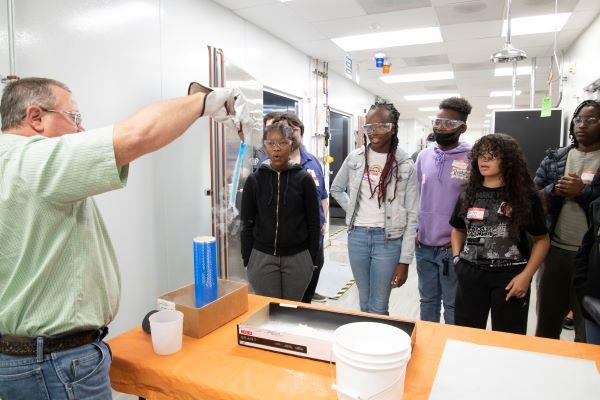 teacher showing students an experiment