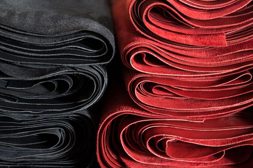 black and red rolls of leather at a tannery