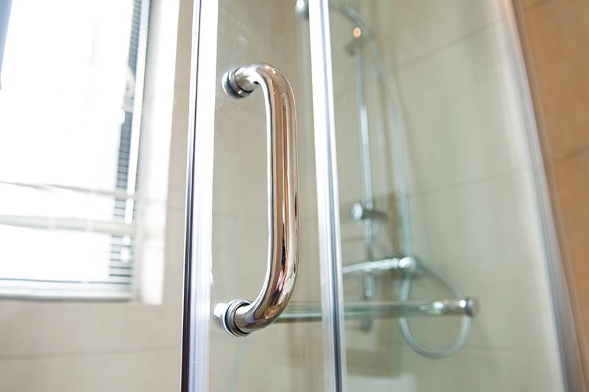 closeup of a clear door to a shower stall