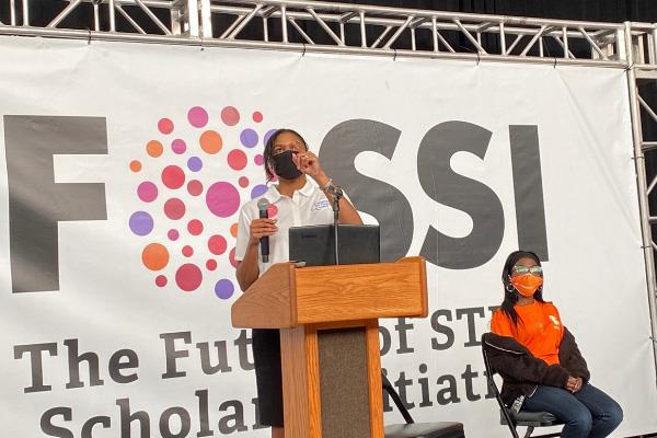 FOSSI event lectern with a person speaking