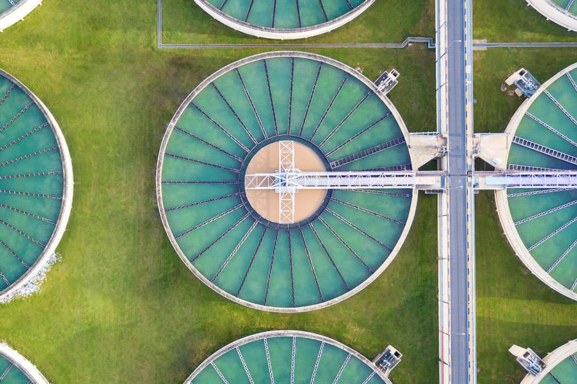 aerial view of round tanks at water treatment plant